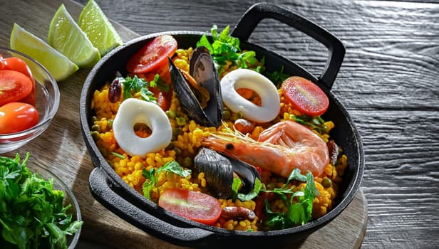 Seafood paella served in a cast iron pan.