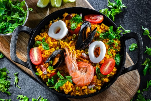 Seafood paella served in a cast iron pan.
