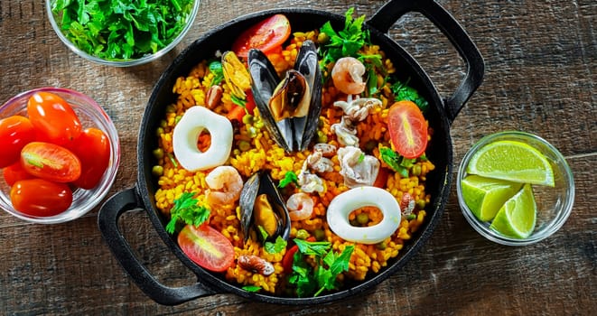 Seafood paella served in a cast iron pan.