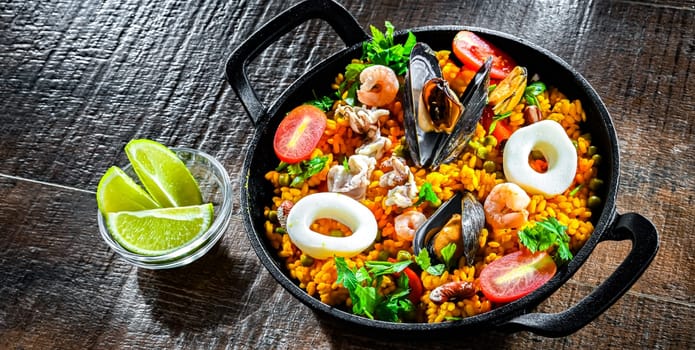 Seafood paella served in a cast iron pan.