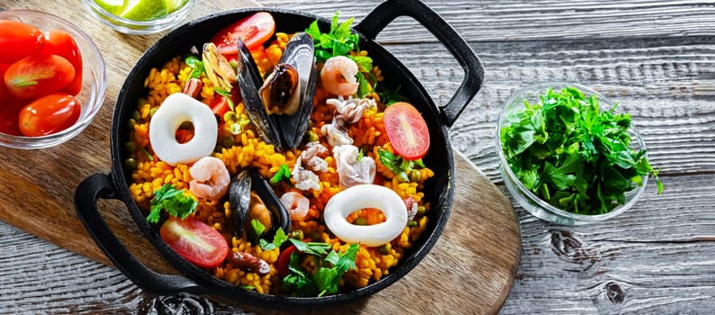 Seafood paella served in a cast iron pan.