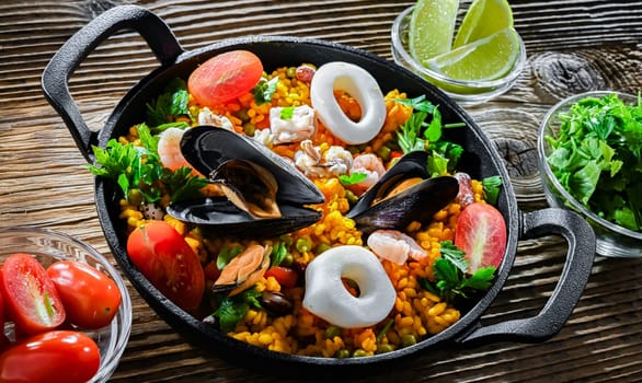 Seafood paella served in a cast iron pan.
