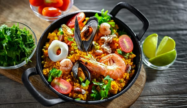 Seafood paella served in a cast iron pan.