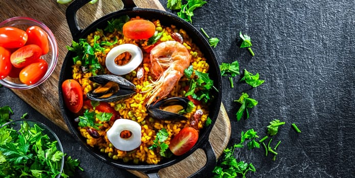 Seafood paella served in a cast iron pan.