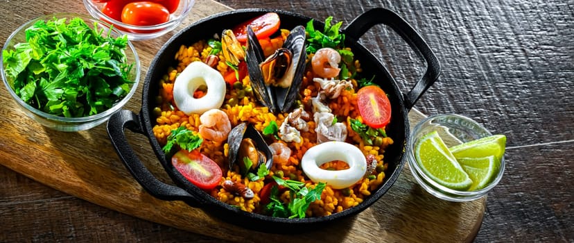Seafood paella served in a cast iron pan.