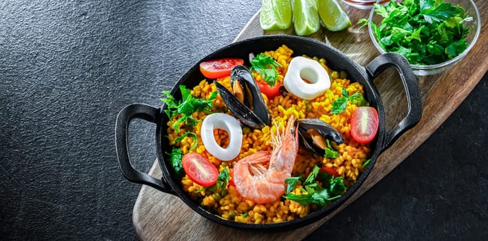 Seafood paella served in a cast iron pan.