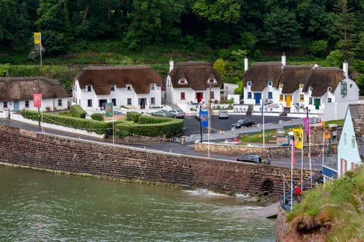Thatched cottage in the popular tourist and fishing village of Dunmore East in County Waterford, Republic of Ireland.