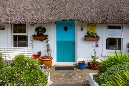 Thatched cottage in the popular tourist and fishing village of Dunmore East in County Waterford, Republic of Ireland.