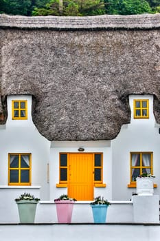 Thatched cottage in the popular tourist and fishing village of Dunmore East in County Waterford, Republic of Ireland.