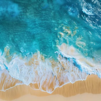 Ocean waves on the beach as a background. Beautiful natural summer vacation holidays background. Aerial top down view of beach and sea with blue water waves