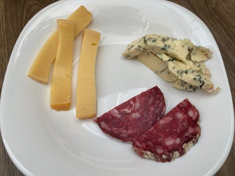 Sliced ​​meat and cheese in a the plate