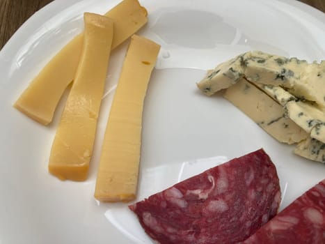 Sliced ​​meat and cheese in a the plate
