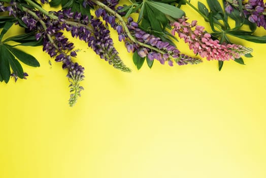 Yellow paper mockup for text with decor made of flower lupine
