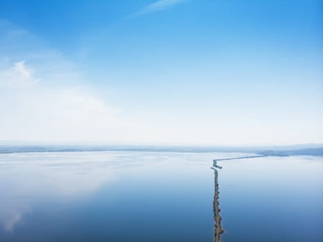 Aerial drone view of sea landscape with road in sunny summer