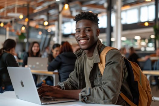 Young man working hard on laptop in busy cafe. Student, studies