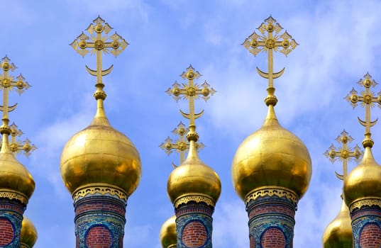 Onion domes on the roof of the Church of the Deposition of the Robe in the grounds of the Kremlin in Moscow in the Russian Federation.