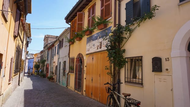 Rimini, Italy - June 25, 2024: Mural on wall at Borgo San Giuliano typical street with low and colorful houses at Rimini, Italy