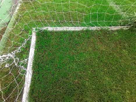 Empty soccer gate at the green grass stadium