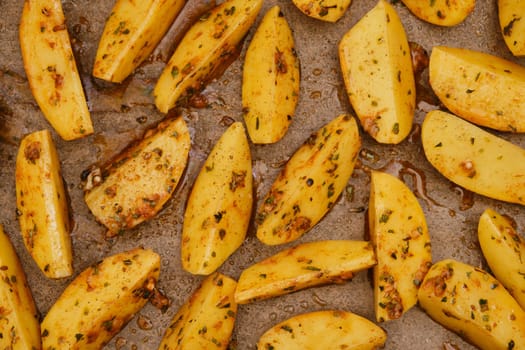 Closeup top view of potato wedges baked in oven