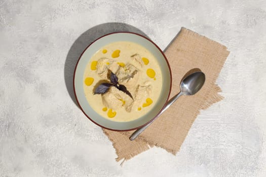 Overhead view of traditional Georgian cold dish satsivi - boiled chicken meat and walnut sauce