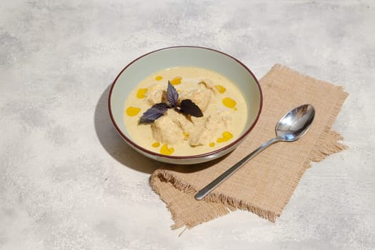 Traditional Georgian cold dish satsivi - boiled chicken meat and walnut sauce