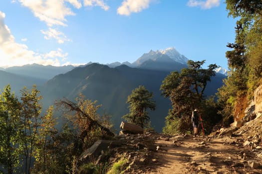 Hiker at golden hour on the trail between Salleri, Phaplu, Bupsa, Jubing and Lukla, Nepal 2022