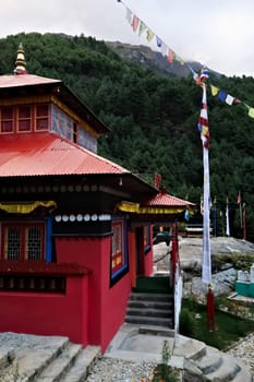 The red main building of the monastery built on a hill in the Monjo, Manjo village on the Mount Everest Basecamp Trek, EBC, Nepal 2022
