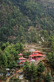 View onto the red monastery built on a hill in the Monjo, Manjo village on the Mount Everest Basecamp Trek, EBC, Nepal 2022