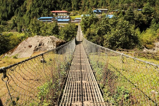 The long PHakding suspension bridge leading to the village of Phakding, Mount Everest Basecamp Trek, EBC, Nepal 2022
