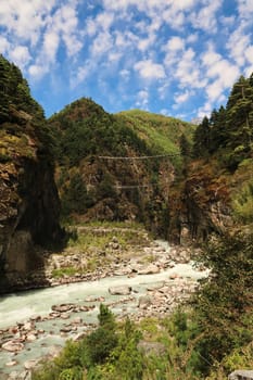 View onto the famous Hillary bridge, a double suspension bridge over the Dudh Khosi River between Phakding and Namche Bazar, Bazaar, Mount Everest Basecamp Trek, EBC, Nepal 2022
