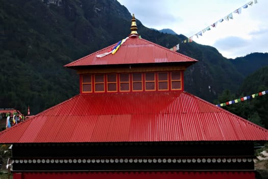 The red roof of the monastery built on a hill in the Monjo, Manjo village on the Mount Everest Basecamp Trek, EBC, Nepal 2022