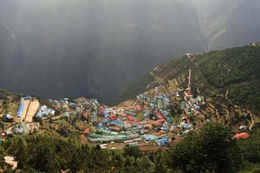 Spectacular view onto Namche Bazaar, Bazar before sunset, the sun is shining in visible sun rays on the colorful houses, Mount Everest Basecamp Trek, EBC, Nepal 2022