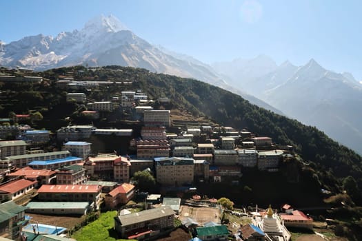 View over Namche Bazar, Bazaar, mountains are rising in the background, Mount Kusum Kanguru, Kangguru on the right and Mount Thamserku on the left, Mount Everest Basecamp Trek, EBC, Nepal 2022