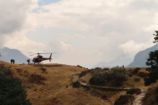 A helicopter is about to take off from the heliport close to the Mount Everest view point above Namche Bazar, Bazaar, close to Khumjung village, Mount Everest Basecamp Trek, EBC, Nepal 2022