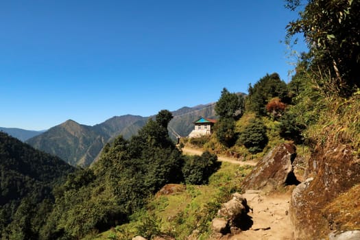 The trail between Salleri and Lukla, passing a teahouse with prayer flags, Mount Everest Basecamp Trek, Nepal 2022
