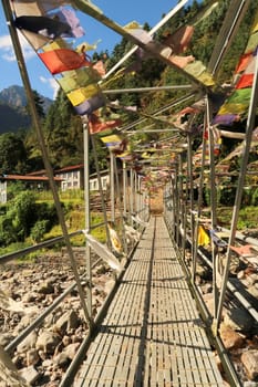Metal bridge with prayer flags between Salleri and Lukla, Mount Everest Basecamp Trek, Nepal 2022