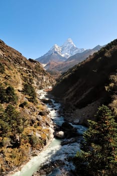 View from the Imja River suspension bridge, the Imja Khola River in the foreground, the village of Pangboche in front of Ama Dablam in the background, Mount Everest Base Camp Trek, EBC, Nepal 2022