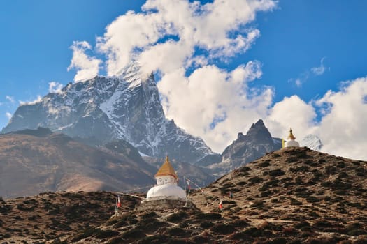 Two hills with stupas, pagodas in front of the peak of Mount Tobuche, Dingboche village, Mount Everest Base Camp Trek, EBC, Nepal 2022