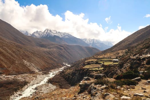 View on the trail between Pangboche and Dingboche, a traditional farmhouse next to the Imja Khola River can be seen in the foreground, Mount Thamserku in the background, Mount Everest Base Camp Trek, EBC, Nepal 2022