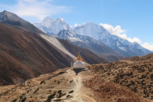 View onto a stupa, pagoda on a hill outside of Dingboche village, the peaks of Mount Thamserku and Kangtega can be seen in the background, Mount Everest Base Camp Trek, EBC, Nepal 2022