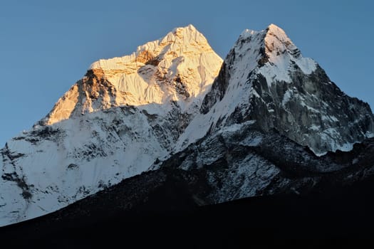The snow capped peaks of Mount Amphu Gyabjen and Mount Ama Dablam at sunset, Dingboche village, Mount Everest Base Camp Trek, EBC, Nepal 2022