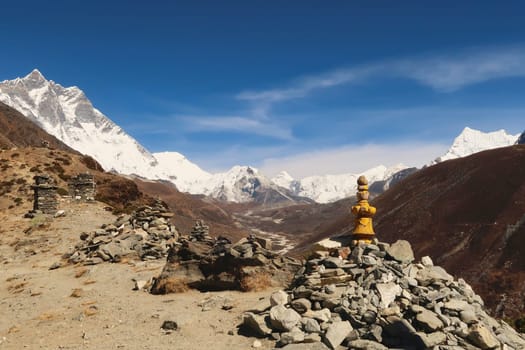 Stacks, piles of stones, rocks on the way to the Dingboche view point, Mount Lhotse and Island peak can be seen in the background, Mount Everest Base Camp Trek, EBC, Nepal 2022