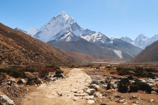 Walking through Pheriche valley, Pheriche village in the distance in front of Mount Amphu Gyabjen, Ama Dablam, Kangtega and Thamserku, Mount Everest Base Camp Trek, EBC, Nepal 2022