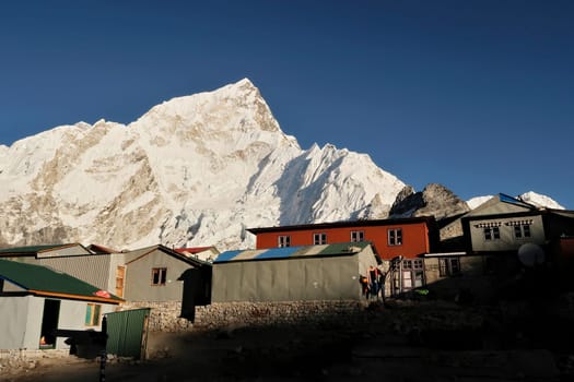 Houses of the village of Gorakshep, Gorak Shep in front of Mount Nuptse at sunset, golden hour, Mount Everest Base Camp Trek, EBC, Nepal 2022