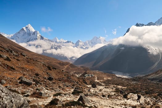 Walking up towards the Everest Memorial Chukpi Lhara, the Dughla, Thukla village in the foreground, Mount Amphu Gyabjen, Ama Dablam, Kangtega and Thamserku in the background, Mount Everest Base Camp Trek, EBC, Nepal 2022