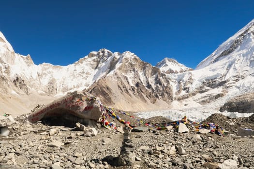 At the Base Camp of Mount Everest, a large rock, boulder, sprayed with red graffiti, paint marks the site, Mount Khumbutse and Changtse are visible in the background, Mount Everest Base Camp Trek, EBC, Nepal 2022