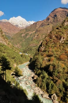 View onto the village of Benkar next to the Imja Khola River, the peak of Mount Thamserku is rising in the background, Mount Everest Base Camp Trek, EBC, Nepal 2022