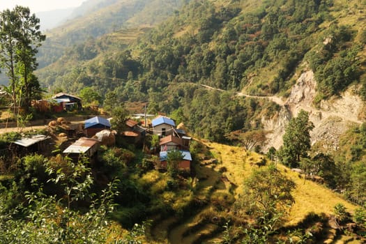 View onto farmhouses and rice terraces, fields, paddies along the trail close to Bahundanda village, Annapurna Circuit Trek, Nepal 2022