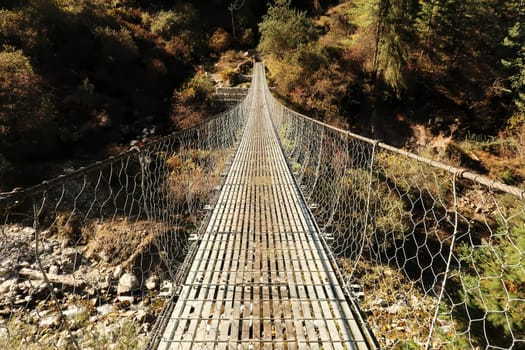 Long metal suspension bridge before entering the village of Timang, Annapurna Circuit Trek, Nepal 2022