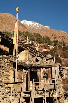 Traditional rural houses, farmhouses on a steep hill in the village of Upper Pisang, built from stone and wood, Annapurna Circuit Trek, Nepal 2022